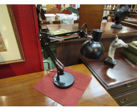 A black metal angle poise style table lamp   