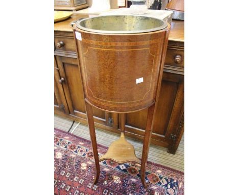 An Edwardian mahogany planter, on tapering supports with undertier &amp; original brass liner