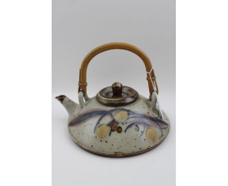 A 20th century studio pottery teapot of squat form, with bamboo handle