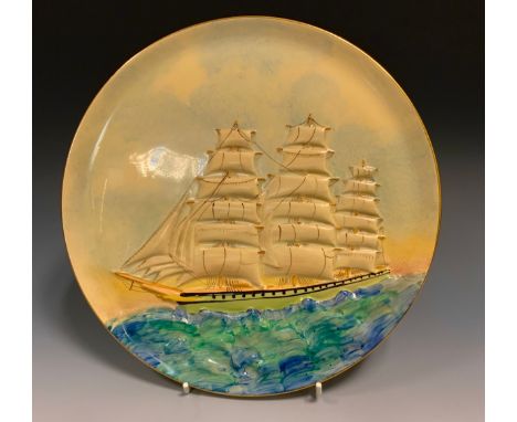 A Grays pottery circular wall plaque, relief decorated with a three masted ship at full sail, 27.5cm diameter, printed marks.