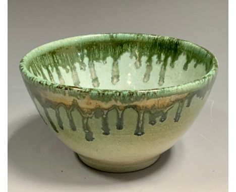 A Dame Lucie Rie style studio pottery bowl, dripped in green on a light jade ground, 7cm deep, 12cm diameter, incised LR sign