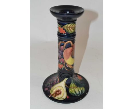 A Moorcroft candlestick in a modern design, probably Queens Choice, factory mark and artists signature to base (factory secon