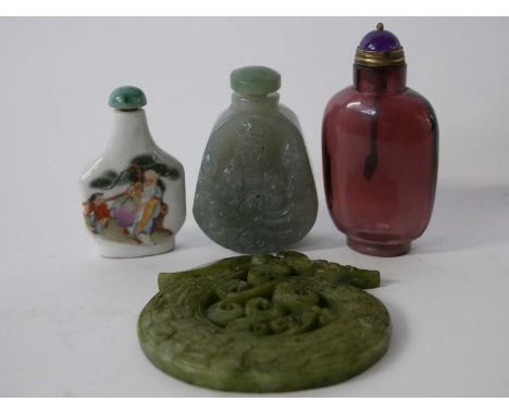 Jade scent bottle with carving of a Chinese deity together with a further porcelain example, an amber glass example and a spi
