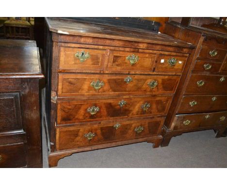 George III walnut veneered and oak chest of three short over three long drawers raised on bracket feet, 102cm wide
