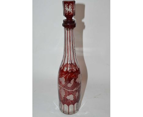 A 19th Century glass decanter, ruby coloured with an engraved design with matching cover