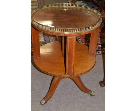 An Edwardian mahogany circular bookcase with brass galleried top, turned column and tripod base with brass paw feet, 68cm hig