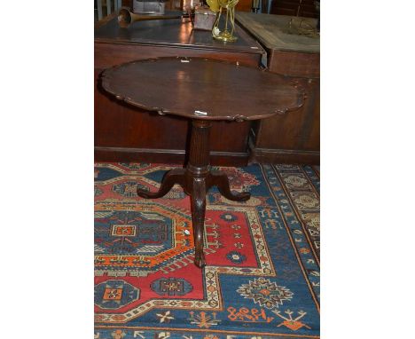 Mahogany supper table with shaped top over a birdcage type support raised on a turned column with tripod base and claw feet, 