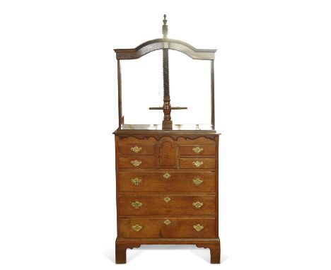 A George III East Anglian oak press chest fitted with a large screw thread and press board over a body with a small central d