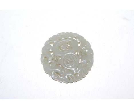 A carved Chinese jade medallion, 5cm diameter