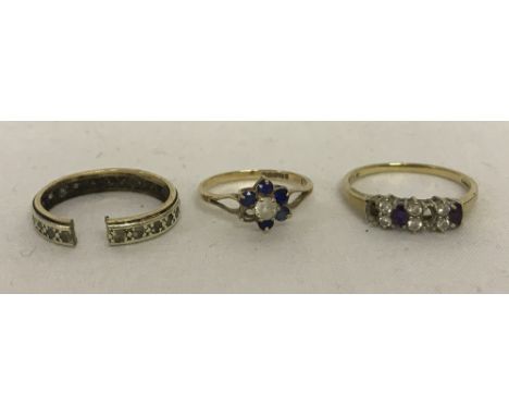  Comprising: an eternity style ring set with clear and purple cubic zirconia stones (some stones missing), a full eternity ri