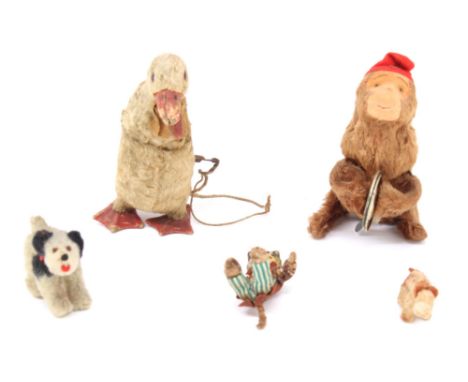 Toys: An Alps clockwork cymbal monkey, together with a clockwork duck, missing hat and cape; and three small figures: two dog