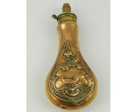 W. Foster & Co. A 19th century embossed brass shot flask, decorated with a pheasant amongst a rural landscape within foliate 