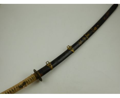 A 19th century Japanese wakizashi, having a black and gold lacquered gilt mounted scabbard, fitted woven hilt (Tang unsigned)