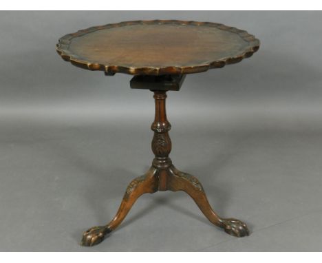A 19th century mahogany pie-crust top tilt-top table, raised on three ball and claw tripod legs, and having a birdcage mechan