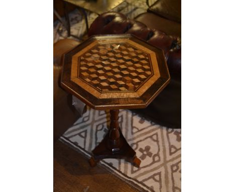 A Victorian rosewood octagonal wine table, the specimen top decorated with perspective cube parquetry, raised on ring turned 