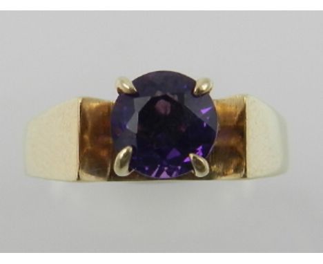 A yellow metal and single stone amethyst set ring, the shank stamped 9K. 