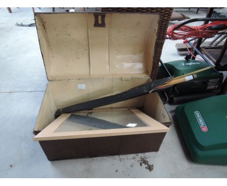 A vintage tin trunk and pool cue