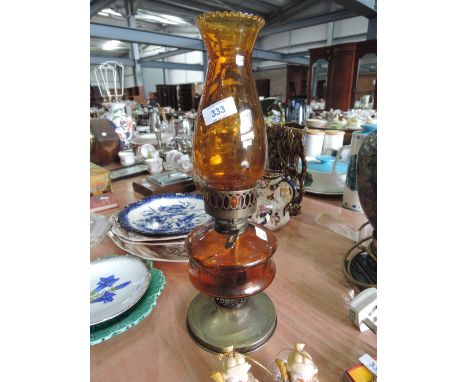 An amber glass oil lamp