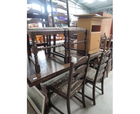 A late 20th century oak dining suite comprising drawer leaf refrectory table and 4 ladder back chairs