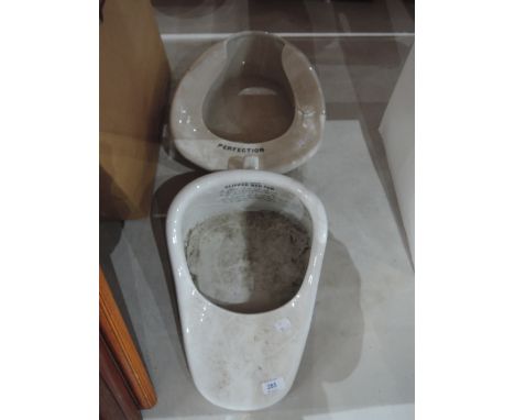 A ceramic slipper bedpan and Perfection bedpan