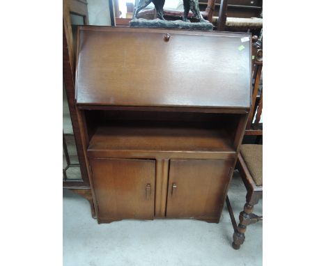A mid 20th Century stained frame bureau with shelf under