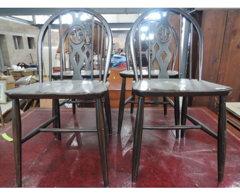 A set of 4 Ercol dark stained kitchen chairs, with 'fleur de lys'