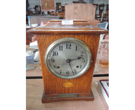 An oak mantle clock by R Bond & Co, Darlington