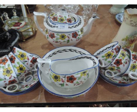 A hand painted part tea service in yellow and orange floral design