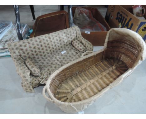 A vintage suitcase containing an early dolls crib and sofa