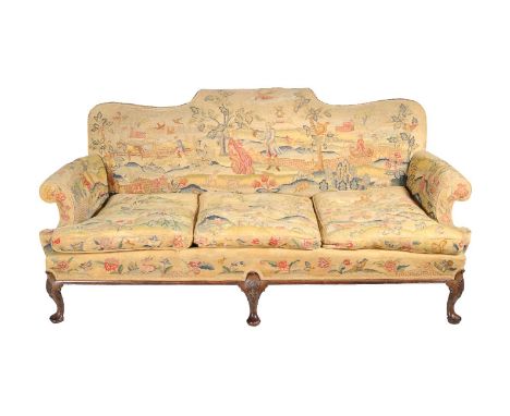 A carved walnut and woolwork upholstered sofa in Queen Anne style, late 19th century, with scrolled back and arms, on cabriol