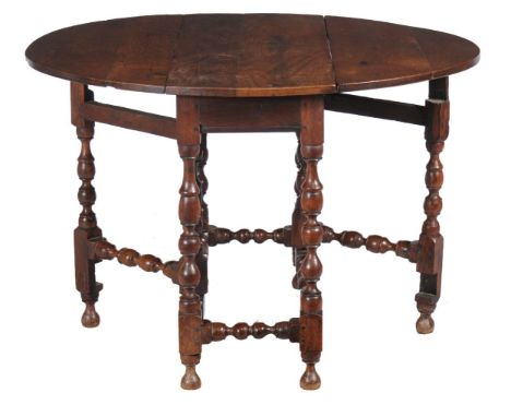 An English oak gate leg table, circa 1700, 74cm high, the top 109cm long, 93cm wide