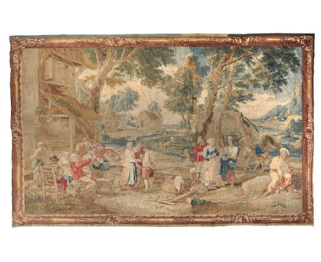 A fine and impressive Franco-Flemish tapestry, 18th century, depicting figures gathered outside a country inn in an expansive