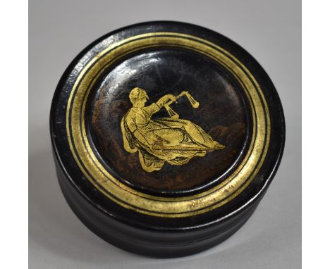 A 19th Century Continental Lacquered Papier Mache Circular Snuff Box, the Lid Decorated with Reclining Greek Goddess Dike Hol