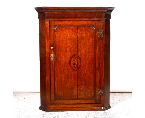 George III oak mahogany hanging corner cabinet, Greek key cornice, plain frieze, the door with oval shell marquetry, enclosin