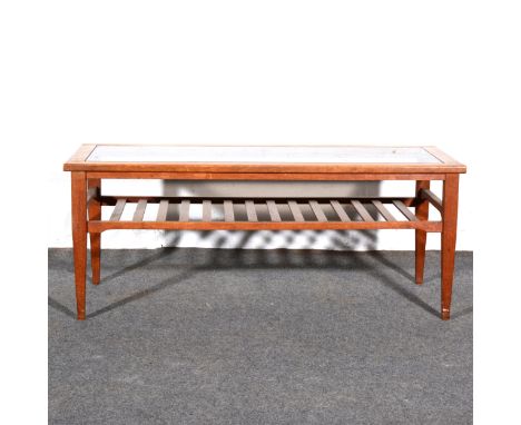 A teak coffee table, smokey plate-glass top, square tapering legs, joined by a slatted shelf, 107cm x 44cm, height 43cm.