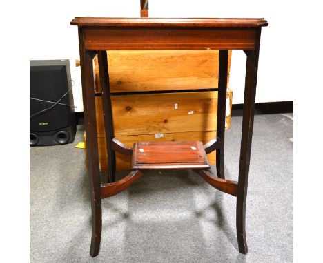 An Edwardian mahogany occasional table, rectangular top with moulded edge, rounded corners, splayed legs joined by a shelf, 5