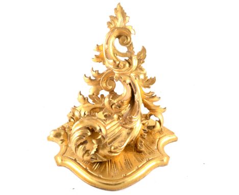 A Florentine style carved wood and gilt gesso corner wall bracket, 32cm.
