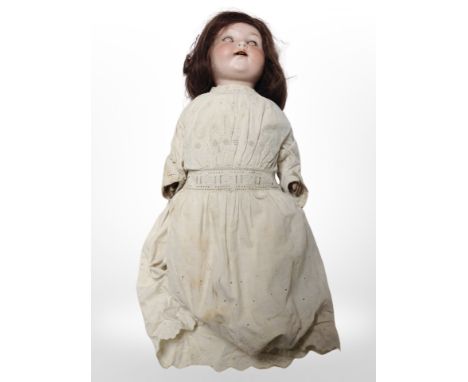 An Armand Marseille poreclain-headed doll stamped 'A.975 M Germany 5'.