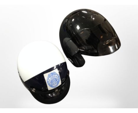 A motorbike helmet marked 'Hawaii County Police', together with a Nolan motorcycle helmet type A.