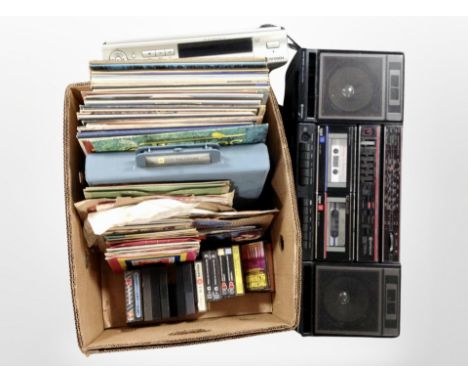 A Hitachi stereo, a Ferguson DVD player, and a box containing assorted LPs, 7-inch singles and cassettes.