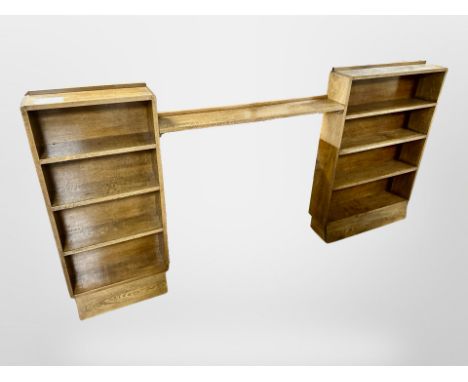 An Edwardian oak two part open bookcase, with central adjoining shelf, 249 cm long x 21 cm deep x 122 cm high 