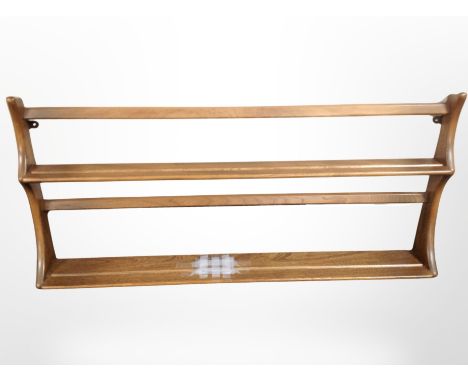 An Ercol stained elm plate rack, width 97 cm