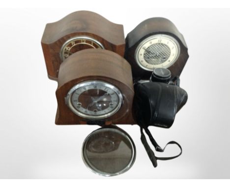 Three antique mantel clocks and a Minolta SRT11 camera.