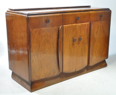 A post war 20th century Art Deco walnut veneer metamorphic sideboard credenza drinks cabinet. The cabinet raised on a plinth 