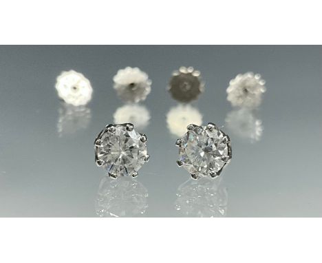 A pair of 18ct white gold diamond solitaire stud earrings,each earring is set with an approx. 0.55ct solitaire diamond in an 