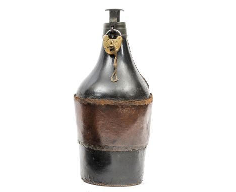 A large flask shaped black leather powder magazine c 1860, height 14½”, the brass baluster top having screw cap secured by a 