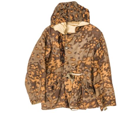 An extremely scarce and desirable Third Reich SS reversible autumn/winter hooded parka, autumn colour very strong, some disco