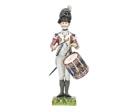 A continental painted porcelain figure “Drummer 1792 First Guards”, in full dress with side drum bearing R Arms and drumstick