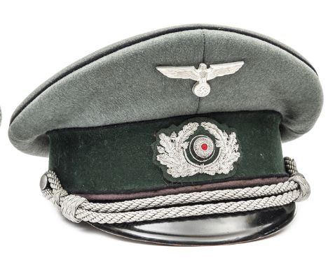 A Third Reich army officer’s peaked cap,  complete with all insignia, cap cords etc, lining marked “Stein Druckfrer Deutsches