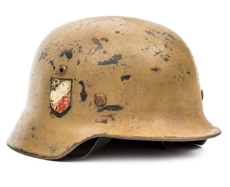 A Third Reich M35 Afrikakorps double decal steel helmet, the original smooth grey/green finish overpainted with matt desert c